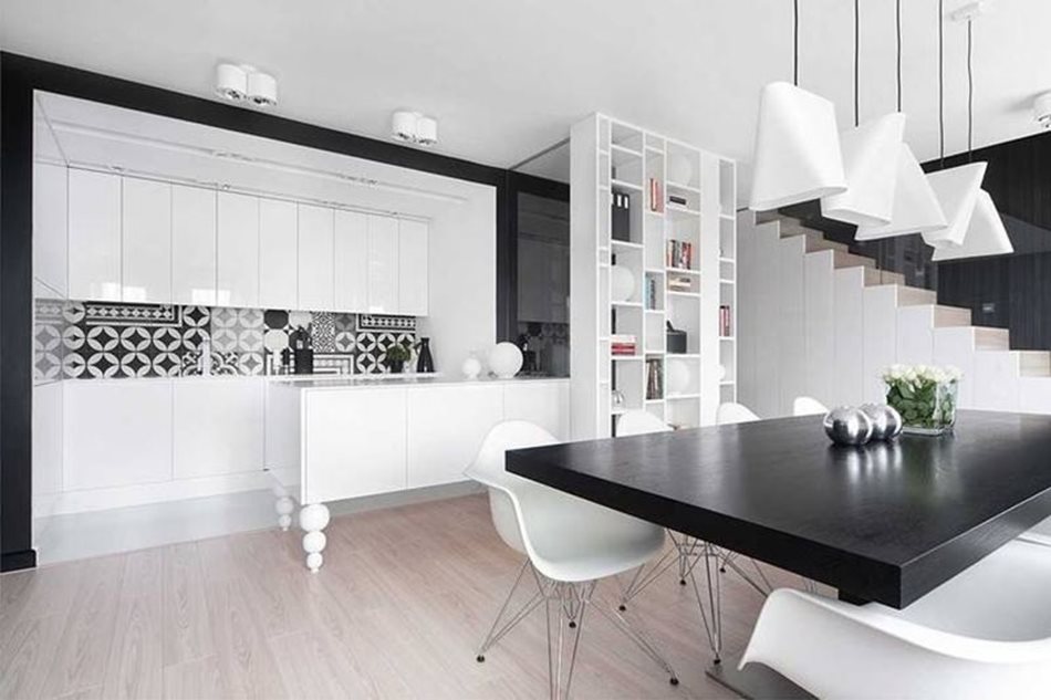 Apartment interior design in black and white colors - The black dining table looks stylish and solidly