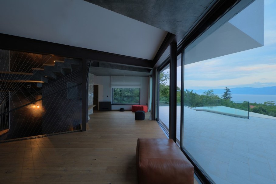 Gumno house - living room with large stained-glass windows