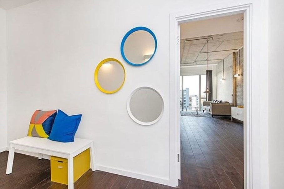 Industrial style London apartment - bright round mirror on the wall of a child's room